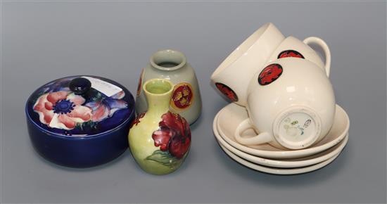 Two Moorcroft small vases, a lidded jar and four cups and saucers